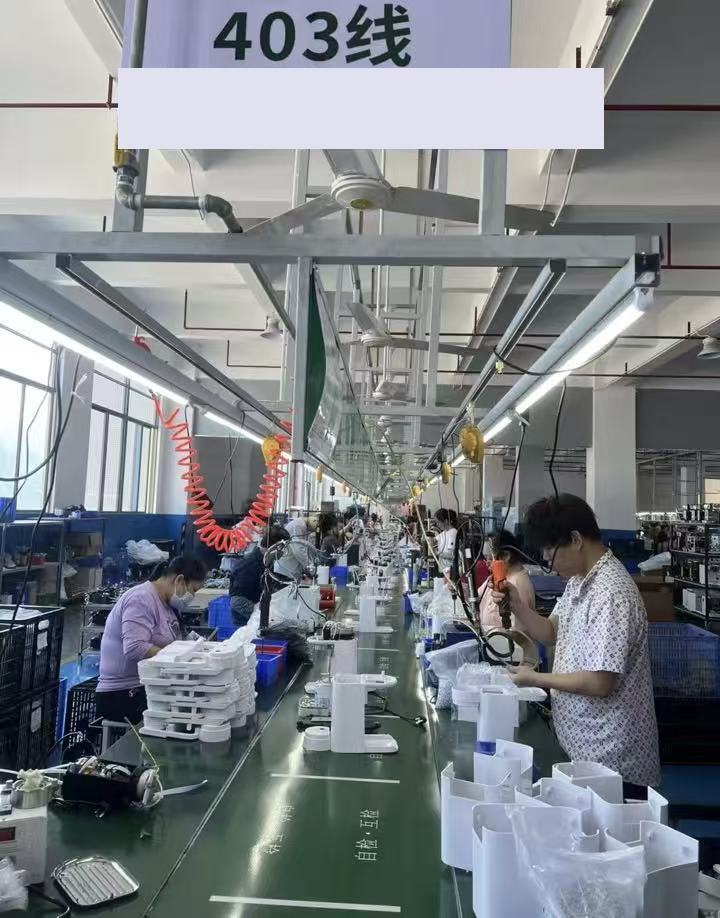 KENVEO small appliance assembly line with operators at production workstations
